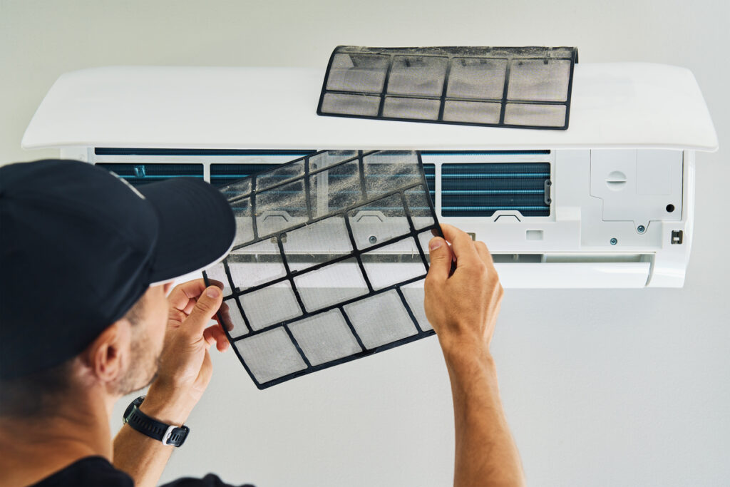 man changing ac filter