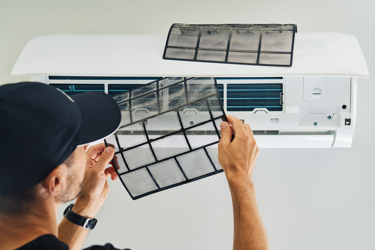 man changing ac filter